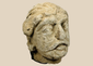 Ancient Gandharan limestone head fragment depicting a Bodhisattva traditionally identified as Maitreya, dating to the Kushan Period.