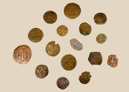 Collection of sixteen ancient Roman and Byzantine bronze coins with natural patina