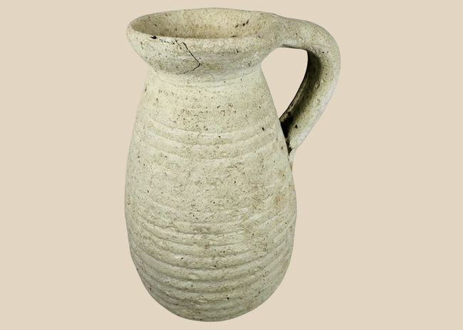 Ancient Roman North African terracotta pitcher from modern Tunisia with ribbed body and loop handle.