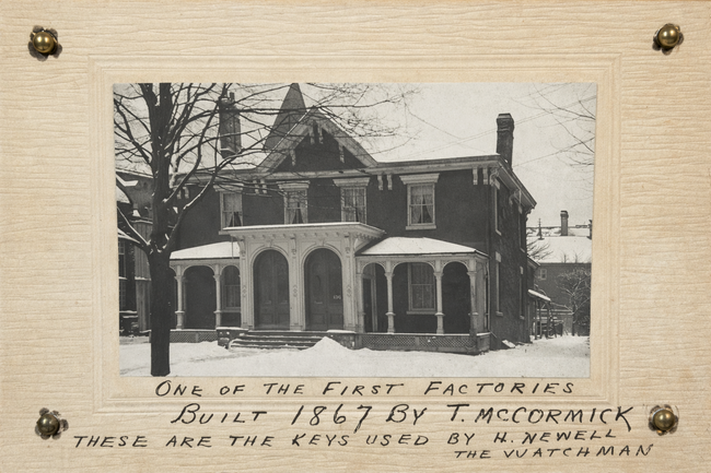 Historic 1867 factory photograph by T. McCormick mounted on card, with handwritten note referencing keys used by watchman H. Newell, displayed