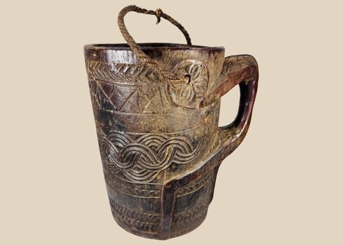 Antique Himalayan carved wooden storage vessel with geometric motifs and rope handle