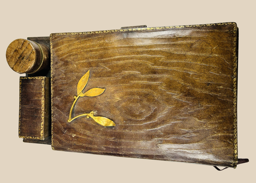 Antique leather writing slope with gilt detailing and inkwell compartment