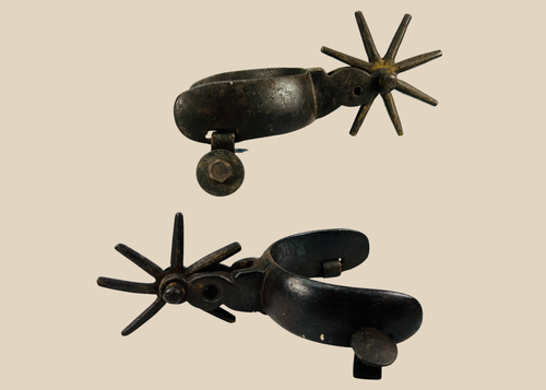 Antique Mexican Charro cowboy spurs with large star rowels and rich patina