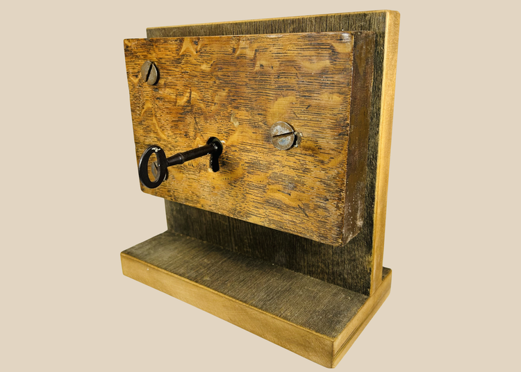 Antique mortise door lock with skeleton key mounted on wooden display