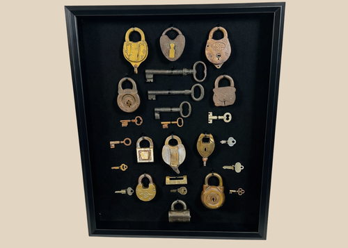 Antique padlocks and skeleton keys collection in shadow box display from the 19th century