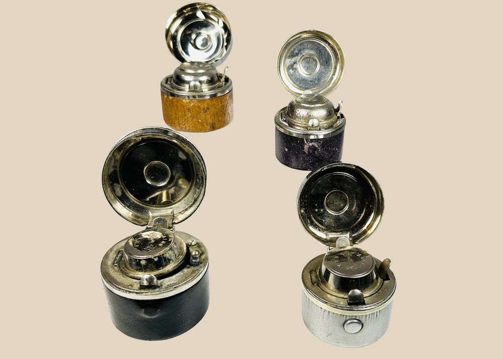 Antique portable inkwells set with leather-wrapped bodies and glass inserts