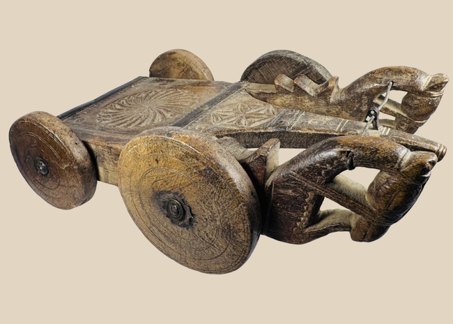 Antique South Asian carved wooden ceremonial cart with four solid wheels and geometric decoration