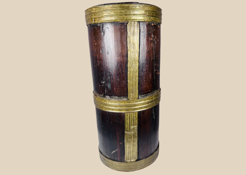 Antique Tibetan hardwood storage vessel with brass bands and traditional Himalayan coopered construction.
