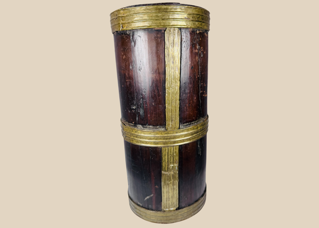 Antique Tibetan hardwood storage vessel with brass bands and traditional Himalayan coopered construction.