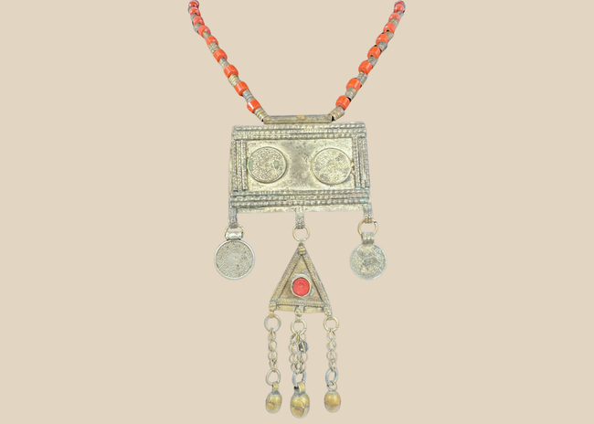 Antique Turkmen tribal necklace with a rectangular pectoral pendant, tumar amulet, and red glass beads.