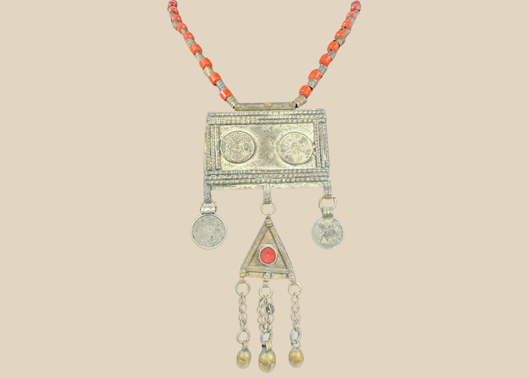 Antique Turkmen tribal necklace with a rectangular pectoral pendant, tumar amulet, and red glass beads.