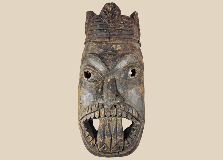 Antique West African ceremonial mask with carved third eye, open mouth, and expressive tribal features.