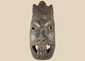 Antique West African ceremonial mask with carved third eye, open mouth, and expressive tribal features.