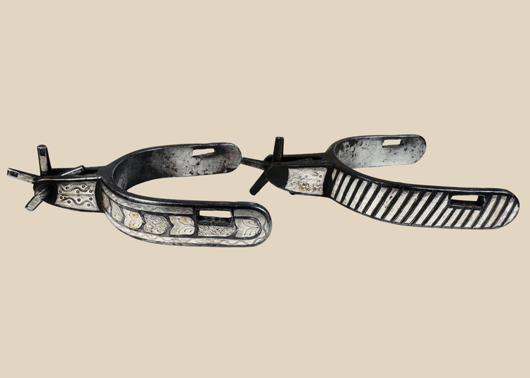 Pair of antique Western steel spurs with engraved silver inlay and five-point rowels