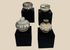 Group of four miniature Sawankhalok glazed stoneware vessels from Thailand's Sukhothai Period, featuring underglaze painted decoration and custom display stands.