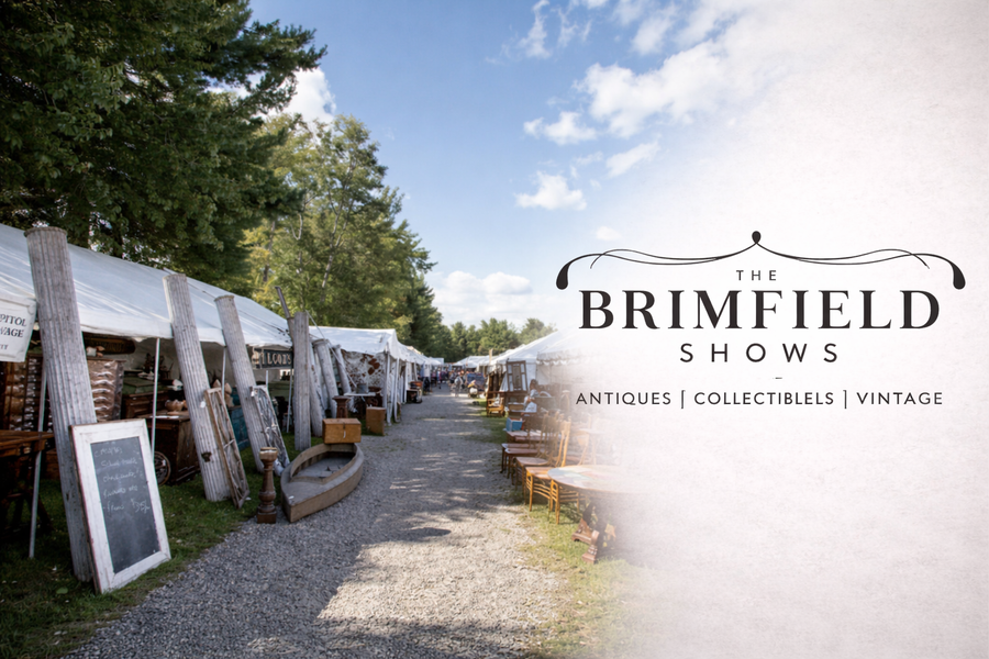 Outdoor antique market at the Brimfield Antique Show with vendor tents displaying vintage furniture, collectibles, and antiques.