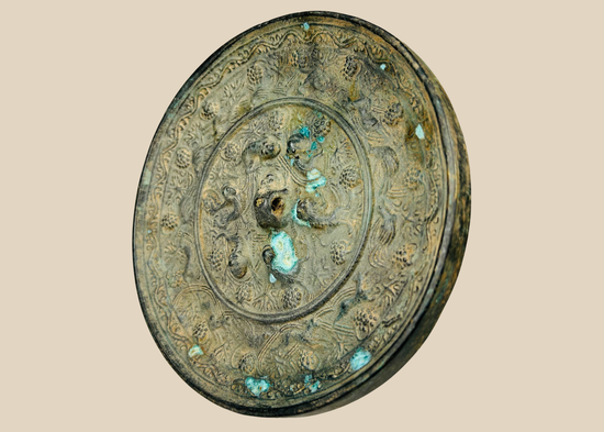 Antique Chinese bronze mirror with sea creature motifs in Tang Dynasty style