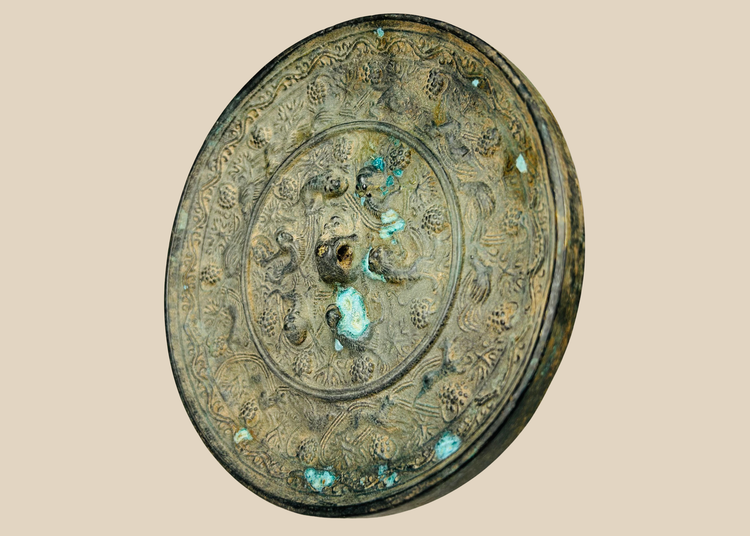 Antique Chinese bronze mirror with sea creature motifs in Tang Dynasty style