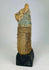 Side view of Ancient Egyptian Bastet cat mummy with detailed linen wrappings and painted mask.