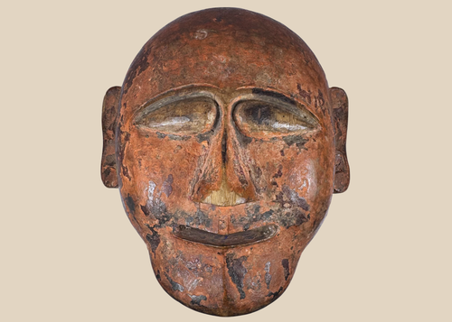 Hand-carved African tribal mask with stylized facial features and aged patina