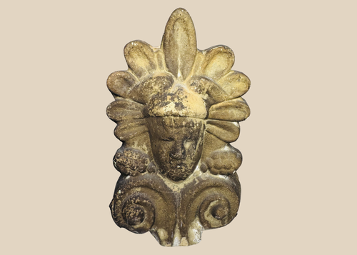 Greek terracotta architectural antefix depicting a stylized human face beneath a palmette crown, dating to the late 19th or early 20th century.