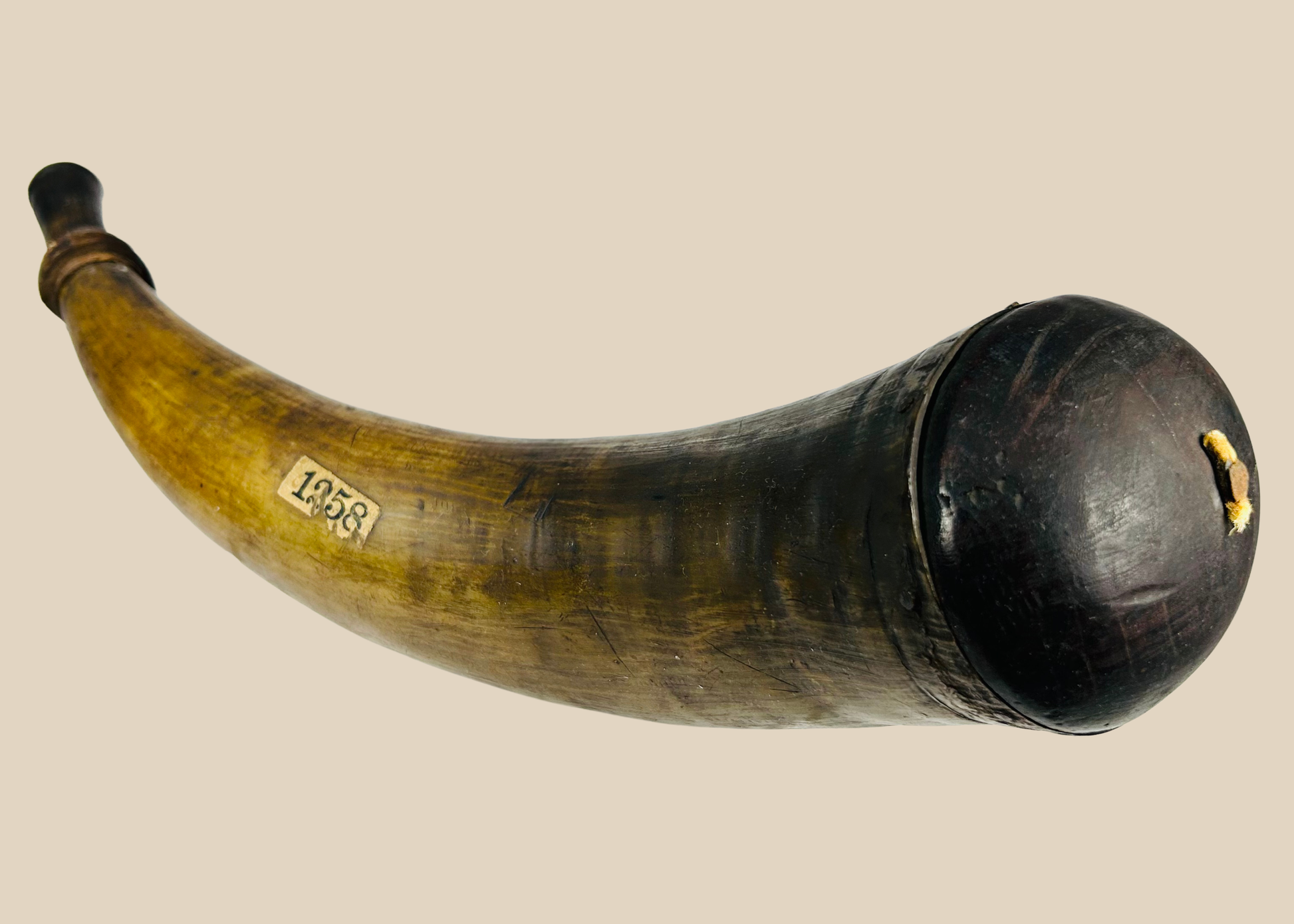 Historic 18th–early 19th century powder horn made from natural animal horn with wooden stopper and fitted base.