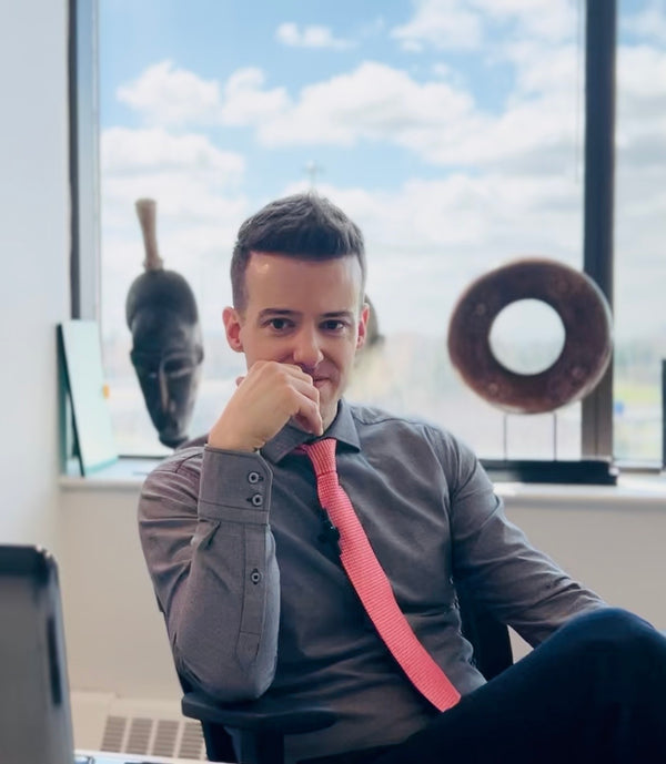 Jordan Thomas, Founder and Head Curator of Relic & Rarity, seated in his Markham, Ontario office surrounded by historical artifacts, reflecting the expertise, research, and dedication behind the gallery's authentication and curation of museum-quality antiquities.