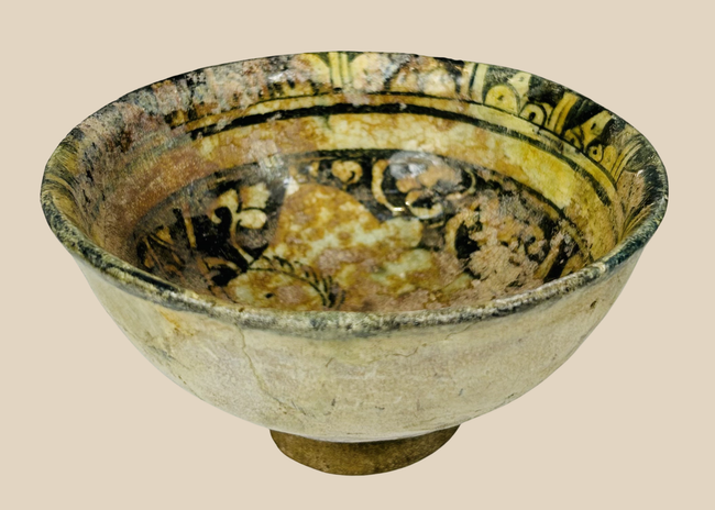 Medieval Islamic glazed ceramic bowl with figural design from Raqqa ware tradition