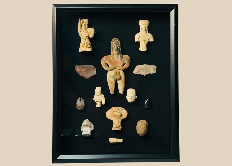 Framed collection of Pre-Columbian terracotta and stone artifacts displayed in a shadowbox.
