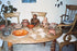 Archival collection photograph showing Pre-Columbian terracotta figures, Sonriente heads, ceramic vessels, and a West Mexican tripod bowl displayed together.