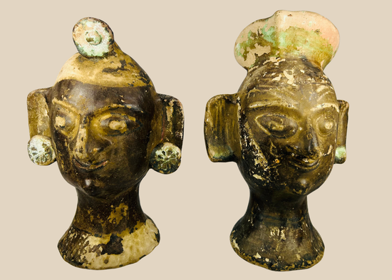 Pair of Pre-Columbian–inspired terracotta head sculptures with headdresses and ear discs, 20th century