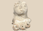 Pre-Columbian terracotta female figure fragment with prominent headdress and stylized facial features, Mesoamerica, circa 300 BCE–600 CE.