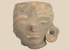 Pre-Columbian West Mexican terracotta head fragment with large ear spool mounted on a custom display stand.