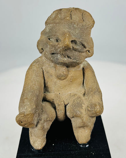 Ancient Pre-Columbian West Mexico seated male terracotta figure with projecting limbs and stylized facial features