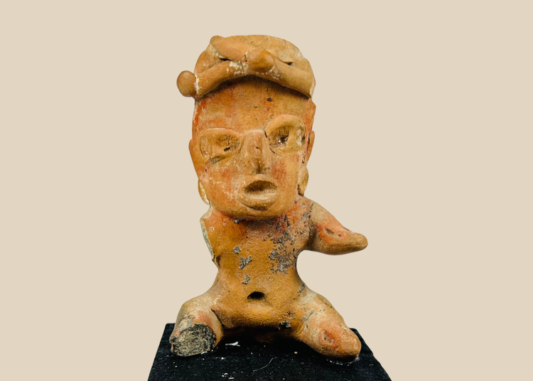 Ancient Pre-Columbian West Mexico seated terracotta figure with stylized face, headdress, and traces of pigment