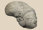 Pre-Columbian terracotta effigy head from West Mexico depicting a stylized human figure with elongated cranial form.