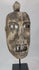 Full 360° spin of an aged tribal wooden mask showing carved eyes, teeth, and surface cracks