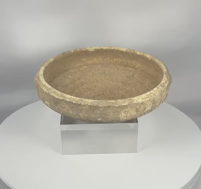 360-degree video showcasing an authentic Roman North African terracotta bowl from Tunisia, highlighting its archaeological patina, surviving white slip, thickened rim, and raised central boss.