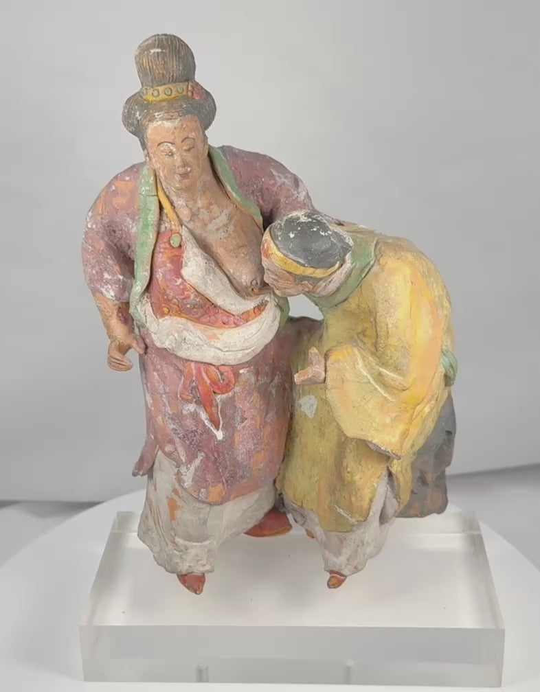 Rotating view of an ancient Chinese painted terracotta group depicting Madam Tang breastfeeding her elderly mother-in-law, with polychrome robes, deeply modeled figures, an unfinished plaster-backed reverse, and a modern acrylic display stand