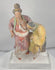 Rotating view of an ancient Chinese painted terracotta group depicting Madam Tang breastfeeding her elderly mother-in-law, with polychrome robes, deeply modeled figures, an unfinished plaster-backed reverse, and a modern acrylic display stand