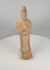 Rotating view of an ancient Tang Dynasty terracotta court lady or attendant with a tall curving headdress, elongated face, hands gathered within voluminous sleeves, floor-length robe, integral hollow base, reddish-orange ceramic body, surviving pale cream slip, traces of pigment, prominent vertical cracking, restored joins, mineral deposits, burial accretions, surface wear, and areas of exposed terracotta