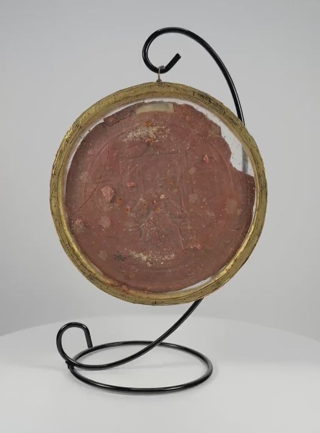 Video showcasing a 17th-century Spanish royal red wax seal, highlighting its detailed enthroned monarch, surrounding Latin inscription, intricate relief, and preserved historical craftsmanship.