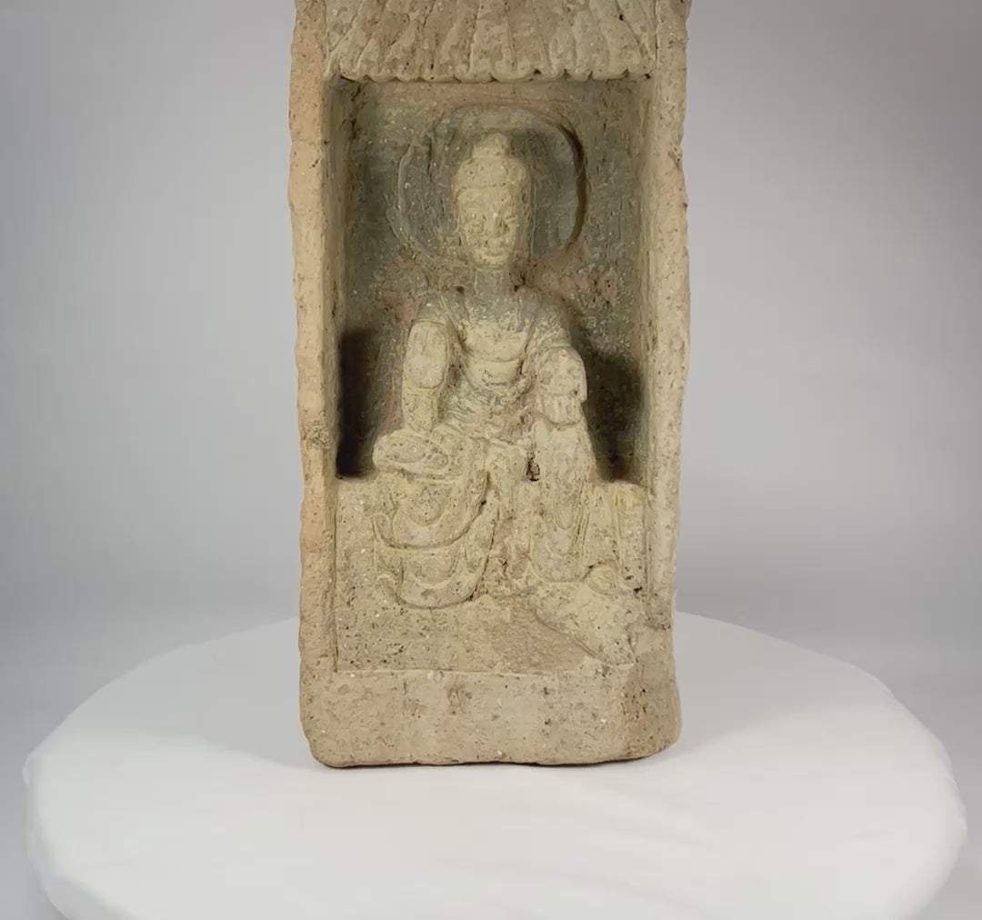 Rotating view of an authentic Chinese Northern Wei Dynasty terracotta Buddha brick, showing recessed shrine niche, haloed seated Buddha, flowing robes, canopy motif, and ancient patina.