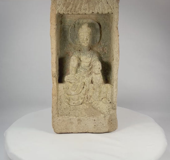 Rotating view of an authentic Chinese Northern Wei Dynasty terracotta Buddha brick, showing recessed shrine niche, haloed seated Buddha, flowing robes, canopy motif, and ancient patina.