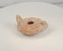 Rotating view of a Late Roman to Early Byzantine mold-made terracotta oil lamp with a central filling aperture, separate wick opening, raised nozzle channel, radiating decoration, solid rear handle, concentric base rings, and burial encrustation