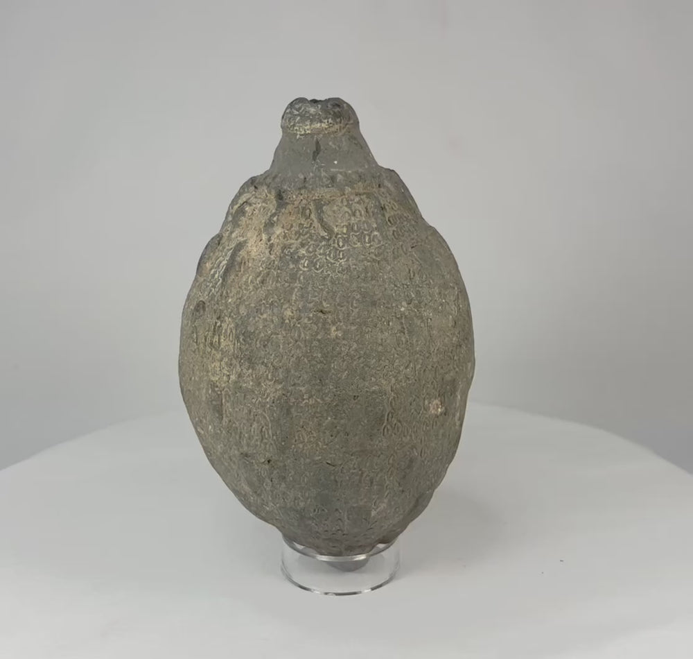 Video of an Islamic ceramic hand grenade from Greater Persia, 10th–12th century CE, showing its globular form, aged patina, and intact structure on display.
