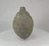 Video of an Islamic ceramic hand grenade from Greater Persia, 10th–12th century CE, showing its globular form, aged patina, and intact structure on display.