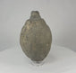 Video of an Islamic ceramic hand grenade from Greater Persia, 10th–12th century CE, showing its globular form, aged patina, and intact structure on display.