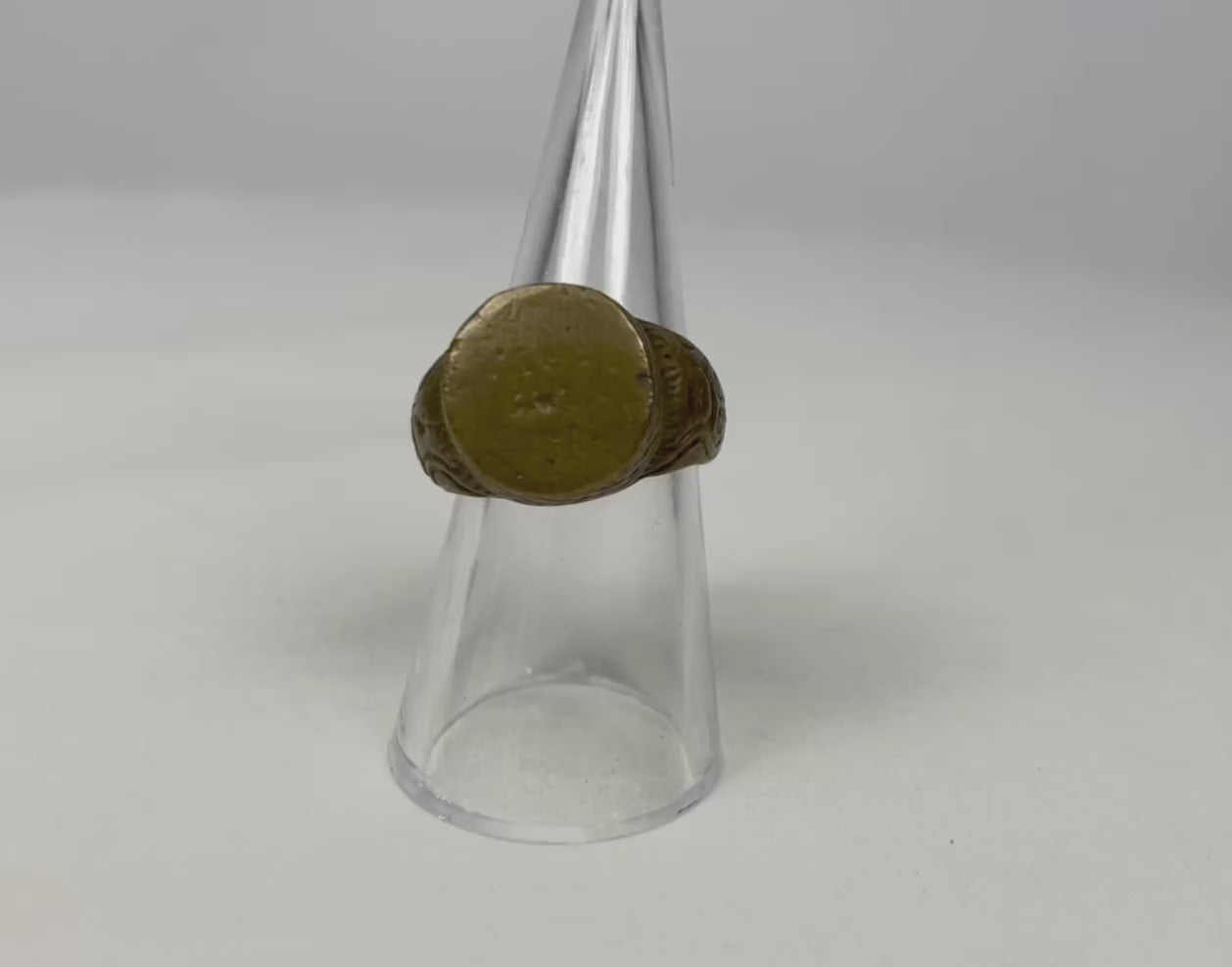 360° video of an ancient bronze ring rotating on a clear display stand