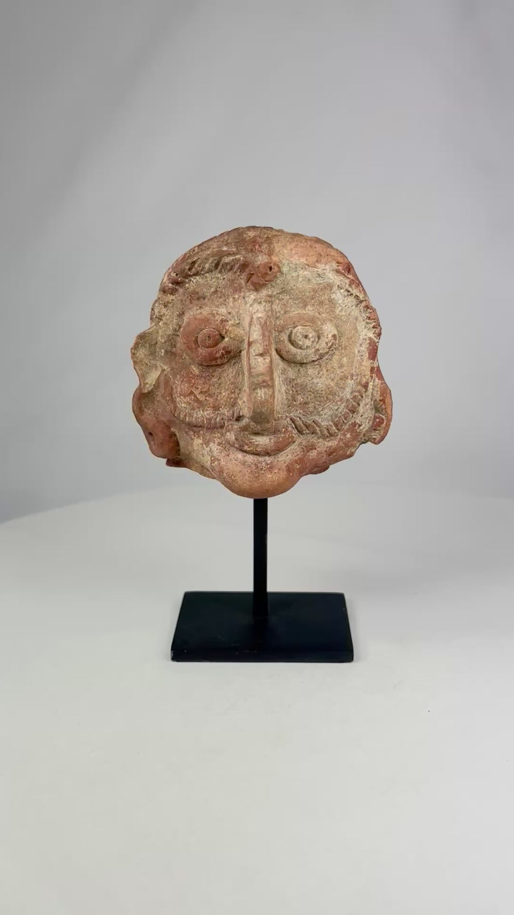 Product video showing an ancient Indian terracotta head from the Shunga period, red clay sculpture dating to the 2nd–1st century BCE